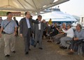 The Secretary for Transport and Housing, Mr Frank Chan Fan (second left), visited Cheung Chau today (November 10). Accompanied by the Chairman of the Islands District Council, Mr Chow Yuk-tong (third left), he greets the public upon arrival at Cheung Chau Pier. 